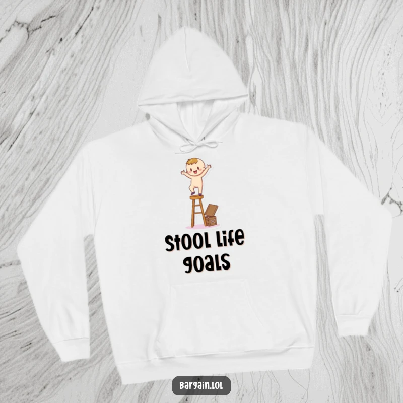 Funny Hoodie: A happy cartoon figure teeters on a stool, reaching for a secret treasure box, embodying determined ambition.